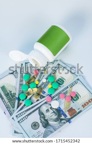 Bottle of pills. Close up picture of money, bottle of pills and drugs