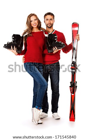 Two young people stand with skiing and ski boots. Winter sports. Isolated over white.