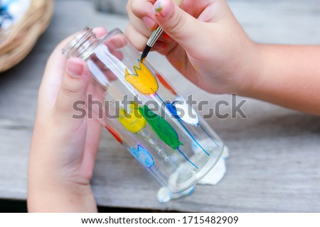 Cute little girl with D.I.Y bottles, 
D.I.Y Plastic Bottle Craft for kids , Crafts with kids, 
Reuse a water bottle , selective focus , Thailand. Royalty-Free Stock Photo #1715482909