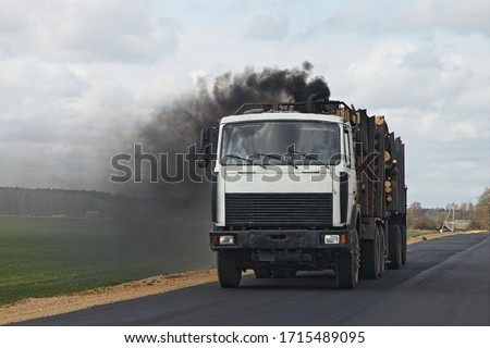 Black smoke from the exhaust pipe of a diesel timber truck, harmful emissions from vehicles ecologe problem Royalty-Free Stock Photo #1715489095