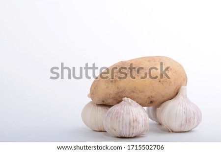 potatoes and garlic on a white background
