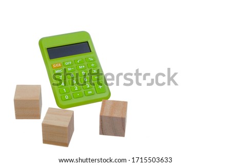 Wooden block house and calculator isolated on white background