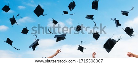 Graduating students hands throwing graduation caps in the air. Royalty-Free Stock Photo #1715508007