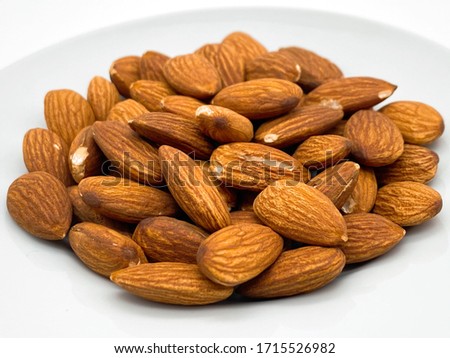 This is a picture of unsalted roasted almonds. Royalty-Free Stock Photo #1715526982