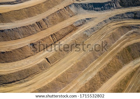 Aerial view of industrial terraces on mineral mine. Opencast mining. Drone view from above. Royalty-Free Stock Photo #1715532802