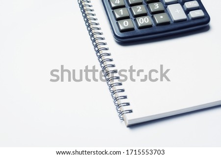 Calculator on notepad with white sheets. Concept analysis of business plan