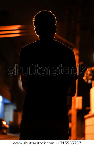 Silhouette image with red background. 