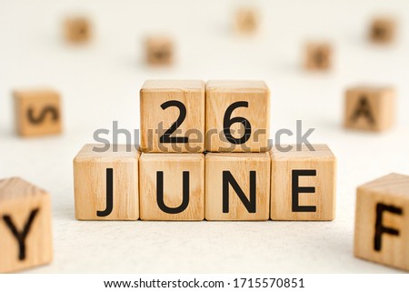 June 26 - from wooden blocks with letters, important date concept, white background random letters around