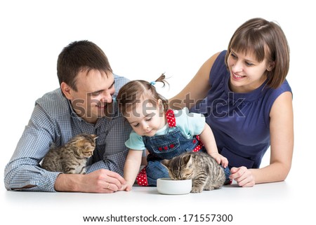 kid girl and her parents feeding small kittens