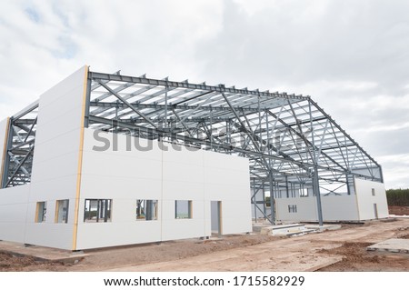 Metal frame of the building with a sandwich panel of insulation on the wall. The use of modern building materials