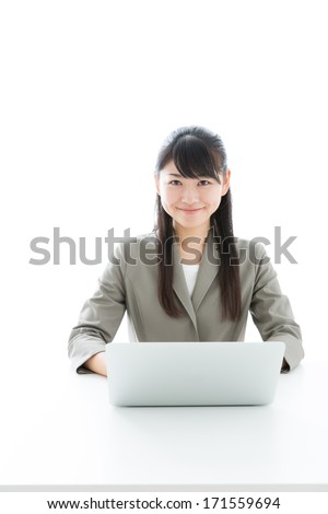 young asian businesswoman using laptop computer on white background