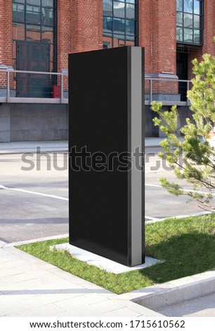 Blank black vertical pylon stand mockup brick building, side view. Empty signplate display or banner for advertising mock up, side view. Clear company commercial tower mokcup template. Royalty-Free Stock Photo #1715610562