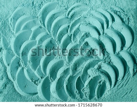 Blue-green cosmetic clay powder (alginate facial mask, spirulina body wrap) texture close up, selective focus. Abstract background. 