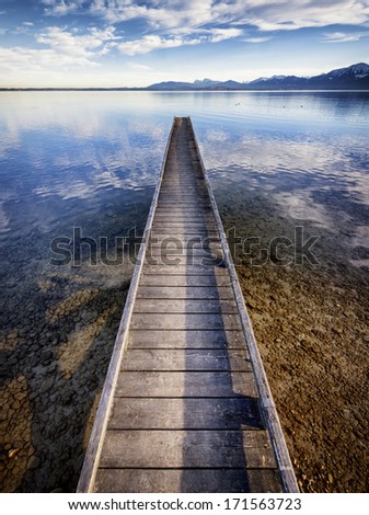 old wooden jetty at the chiemsee lake in bavaria