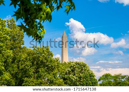 Washington monument on sunny day with blue sky background.
