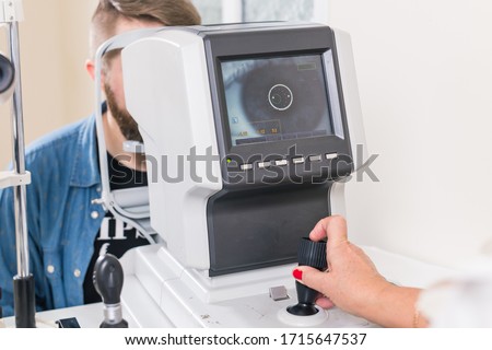Medicine, health, ophthalmology concept - patient checks her vision by an ophthalmologist. Royalty-Free Stock Photo #1715647537