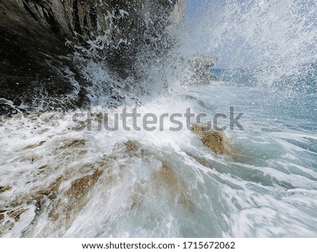Sea wave hits a rock.