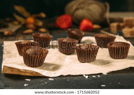 Side view on gourmet chocolate truffles sweets candies dessert on the dark background, horizontal