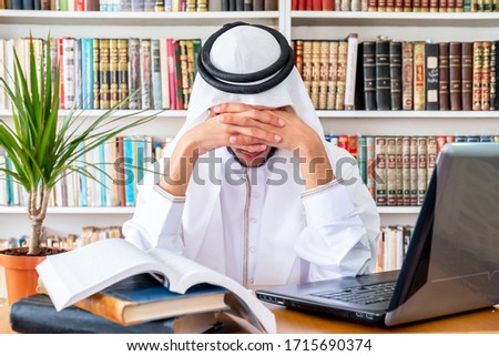 Arabic muslim man feeling upset while studying online
