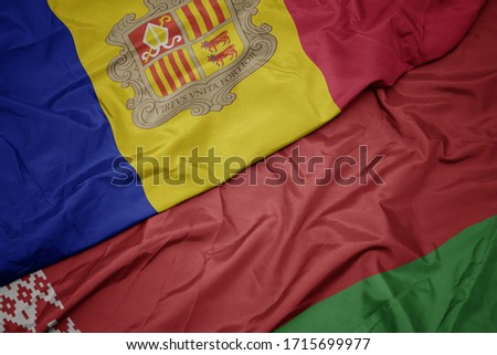 waving colorful flag of belarus and national flag of andorra. macro