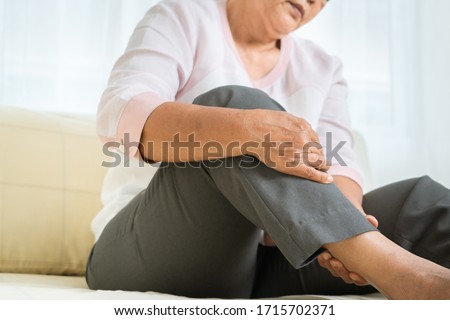 leg pain of senior woman at home, healthcare problem of senior concept Royalty-Free Stock Photo #1715702371