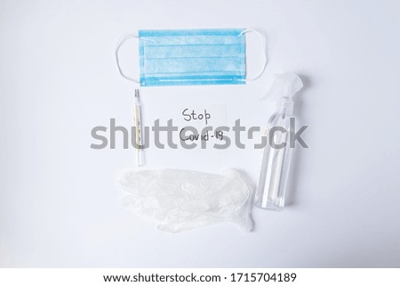 Sign stop Covid-19 with mask, sanitizer, gloves 