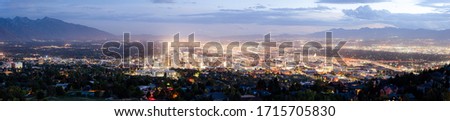 Scenic panoramic view of famous illuminated Salt Lake City downtown area with historic capitol building from Ensign Peak in beautiful twilight with dramatic sunset clouds at night in summer, Utah, USA