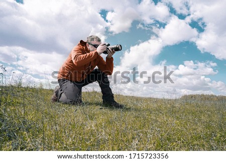 Wild life Nature photographer take a picture in field