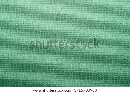 Painted cardboard surface close up. rough texture. abstract green background