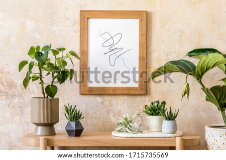 Stylish scandinavian interior of living room with mock up poster frame, wooden console, plants composition, books, decoration, grunge wall and elegant personal accessories in modern home decor.