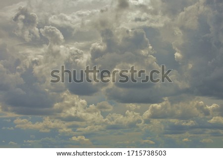 Blue, white and silver textured cumulus cloudscape over the Badlands in the Black Hills of South Dakota