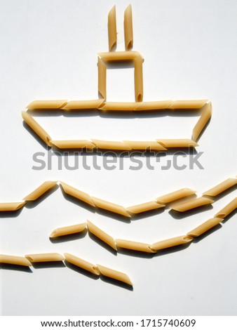 Pasta folded in the shape of a ship and waves. Macaroni pattern on a white background