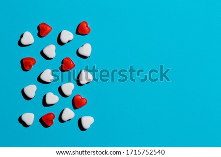 
heart-shaped gelatin candies on a blue background red and white design paren system group