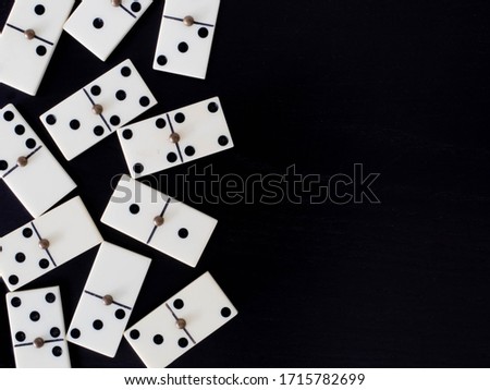 Domino tiles on black background