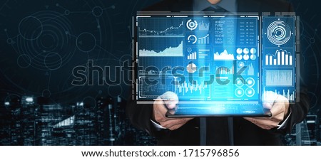 Big Data Technology for Business Finance Analytic Concept. Modern graphic interface shows massive information of business sale report, profit chart and stock market trends analysis on screen monitor. Royalty-Free Stock Photo #1715796856
