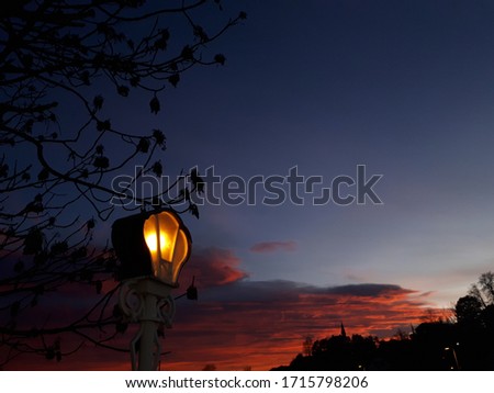 A shining lantern on a sunset background