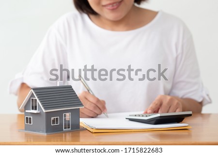 Woman preparing documents file for loan home and refinance Royalty-Free Stock Photo #1715822683