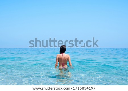 Stock photography of a girl with a pink bikini in the ocean
