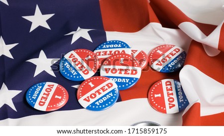 Button of I Voted Today for the US elections with american flag in background. Royalty-Free Stock Photo #1715859175