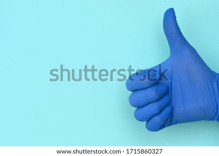hand in latex gloves class gesture on light  background