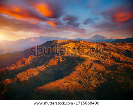 Awesome evening landscape are illuminated by the sunset. Photo of colorful cloudy sky. Location place of Carpathian mountains, Ukraine, Europe. Attractive picture of a countryside. Beauty of earth.
