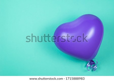 Purple ballon on green background. Copy space.  Top view. 
