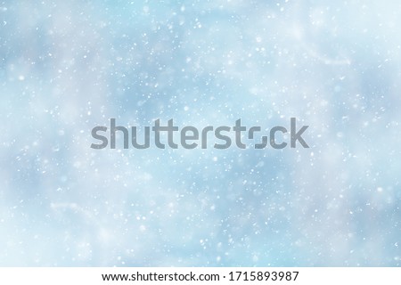blue snowfall bokeh background, abstract snowflake background on blurred abstract blue Royalty-Free Stock Photo #1715893987