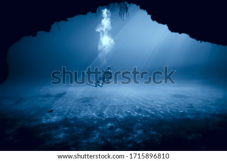 underwater world cave of yucatan cenote, dark landscape of stalactites underground, diver Royalty-Free Stock Photo #1715896810