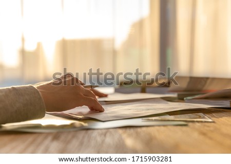 female hand with a pen. writing a document. work from home. doing homework