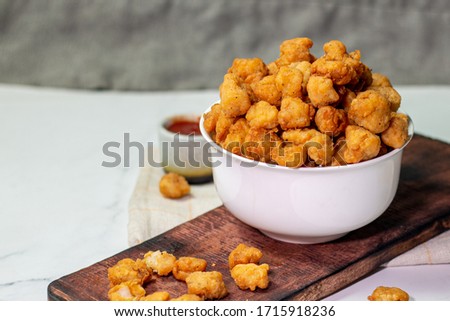 Stock photo of Homemade Crispy Popcorn Chicken with Sauce on white background