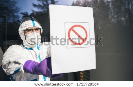 Medic seals off contaminated area during coronavirus (Coivd-19) epidemic in a clinic Royalty-Free Stock Photo #1715928364