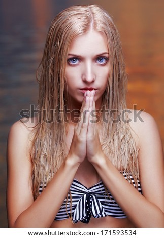 portrait of young beautiful blonde woman with wet hair. sea on background