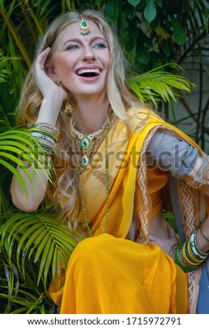 beauty european blonde girl in indian yellow saree