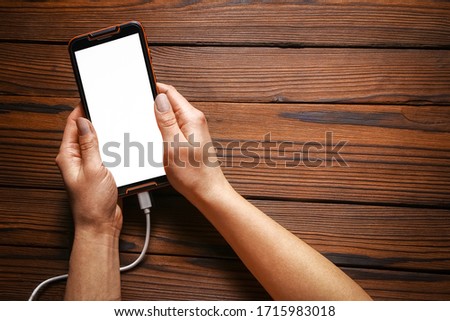 phone with hands addiction on a wooden background
